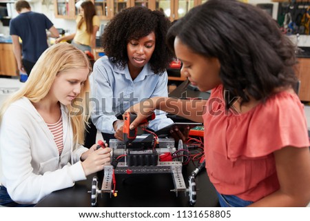 Teacher With Female Pupils Building Robotic Vehicle In Science Lesson Сток-фото © 