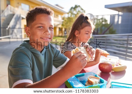 Similar – Image, Stock Photo Child eats sandwich outdoor