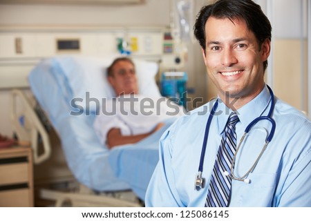 Portrait Of Doctor With Patient In Background