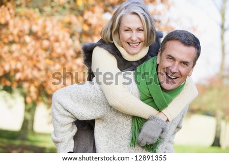 Similar – Image, Stock Photo Woman piggyback on man on street.