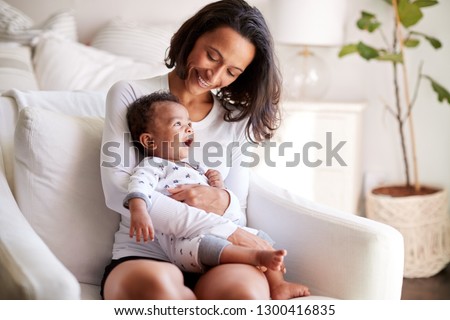 Similar – Image, Stock Photo Young baby sits up in bed with stuffed animal toys; child wearing diaper