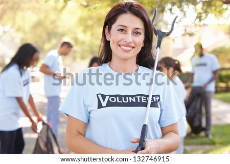 Team Of Volunteers Picking Up Litter In Suburban Street