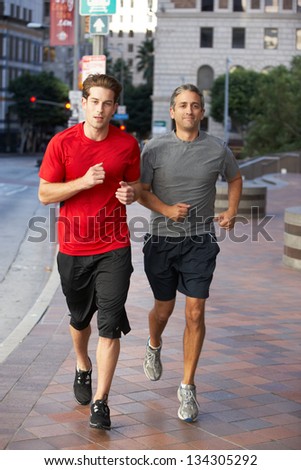 Two Men Running On Urban Street