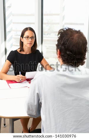 Businesswoman Interviewing Male Candidate For Job