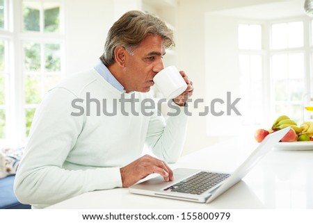 Senior Indian Man Using Laptop At Home