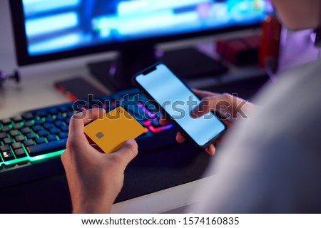 Close Up Of Person With Addiction To Online Gambling Or Shopping Using Credit Card And Mobile Phone ストックフォト © 