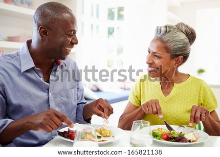 Mature African American Couple Eating Meal At Home