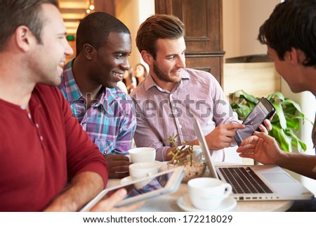 Group Of Male Friends Meeting In Cafe Restaurant