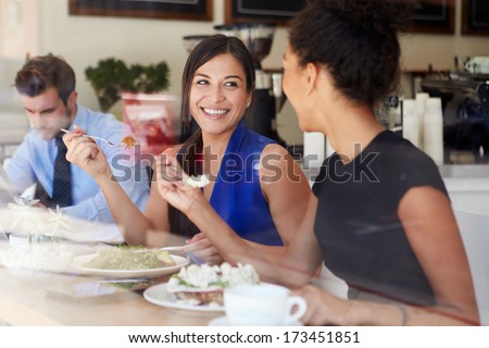 Two Businesswomen Meeting For Lunch In Coffee Shop