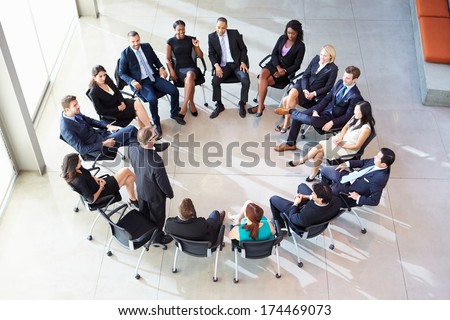 Businessman Addressing Multi-Cultural Office Staff Meeting