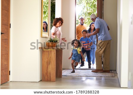 Grandparents At Home Opening Door To Visiting Family With Children Running Ahead Photo stock © 