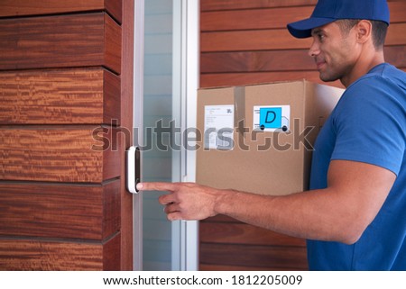 Male Courier Delivering Package To House Ringing Front Doorbell