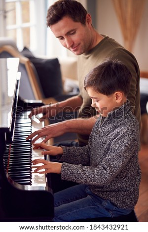 Similar – Image, Stock Photo Smiling child playing piano in cozy room in daylight