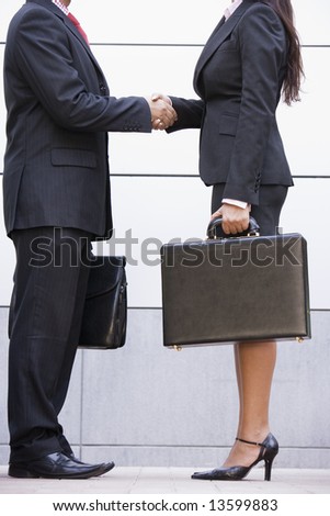 Cropped image of business meeting outside modern office