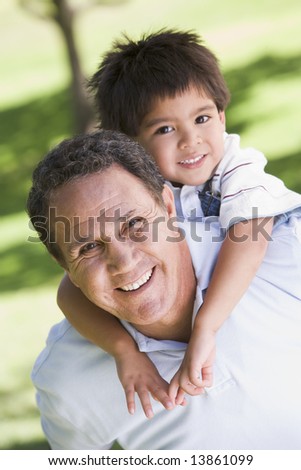 Grandfather piggyback riding grandson