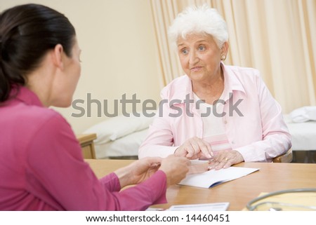 Woman in doctor\'s office frowning