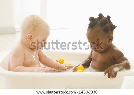 Two babies in bubble bath