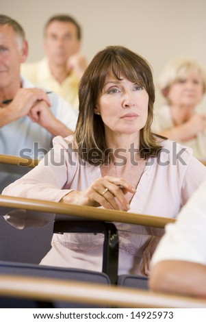Female adult student listening to a university lecture