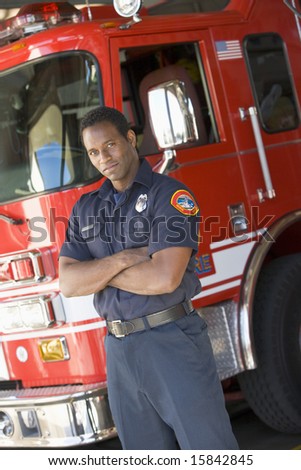 Portrait of a firefighter by a fire engine
