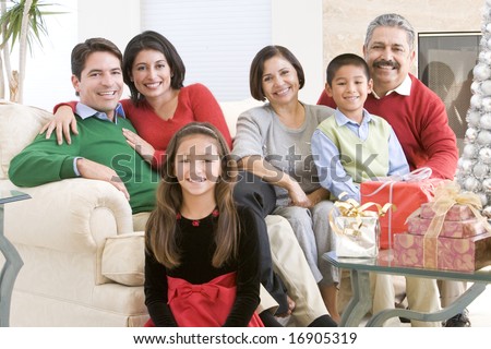 Family Sitting Around A Coffee Table And Christmas Gifts