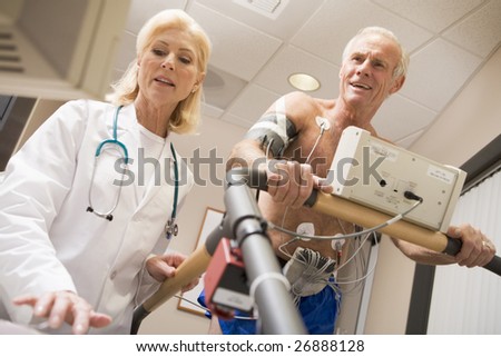 Doctor With Patient While They Run Being Monitored
