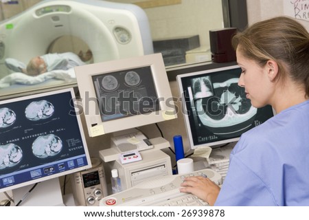 Nurse Monitoring Patient Having A Computerized Axial Tomography (CAT) Scan