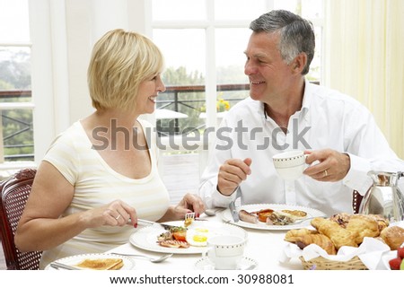 Middle Aged Couple Enjoying Hotel Breakfast