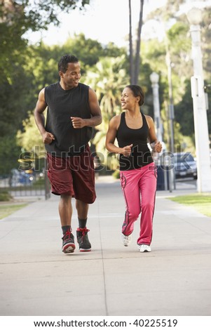 Young Couple Jogging On Street