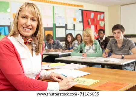 Teenage Students Studying In Classroom With Teacher Stock Photo ...