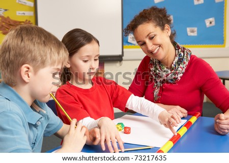 Teacher With School Children In Classroom