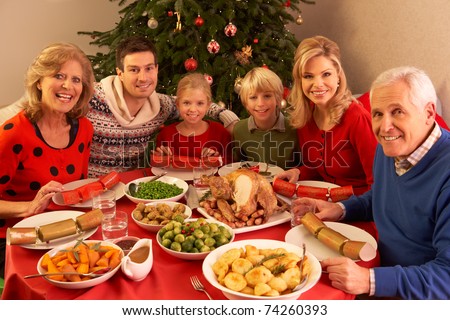 Three Generation Family Enjoying Christmas Meal At Home