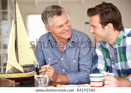 Adult father and son model making