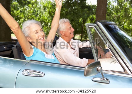 Senior couple in sports car