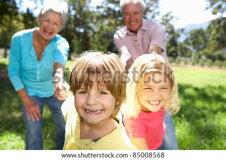 Senior couple on country walk with grandchildren