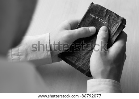 Young man holding bible
