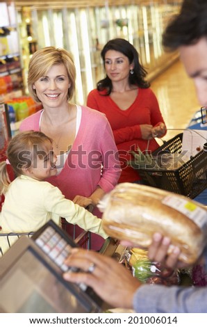 People at supermarket checkout