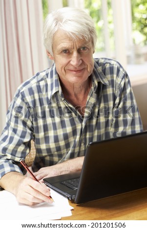 Mid age man working in home office
