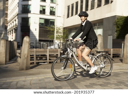Businesswoman cycling to work