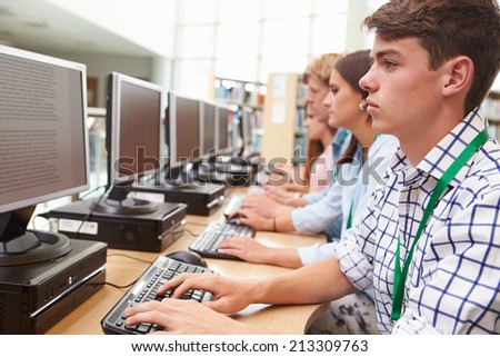 Group Of Students Working At Computers In Library