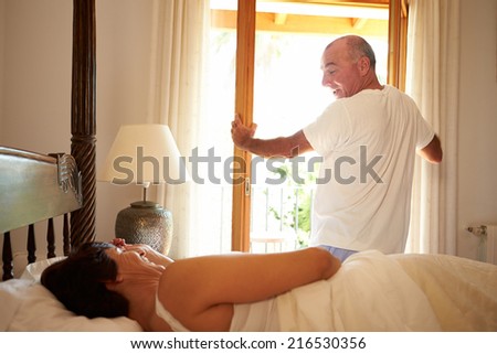Mature Couple Waking Up In Bed In Morning