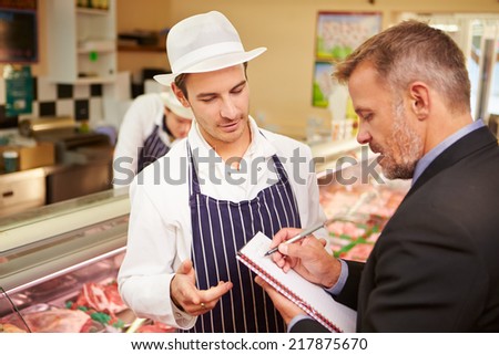 Bank Manager Meeting With Owner Of Butchers Shop