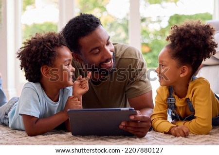 Similar – Image, Stock Photo Father and son using digital tablet together at night in bed