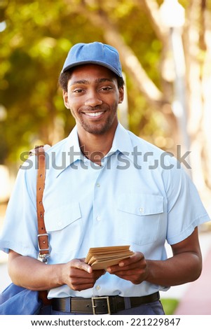 Mailman Walking Along Street Delivering Letters