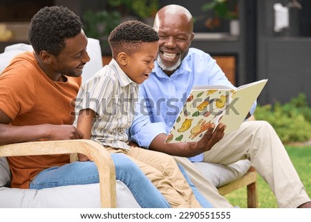 Similar – Image, Stock Photo Father and son reading book together