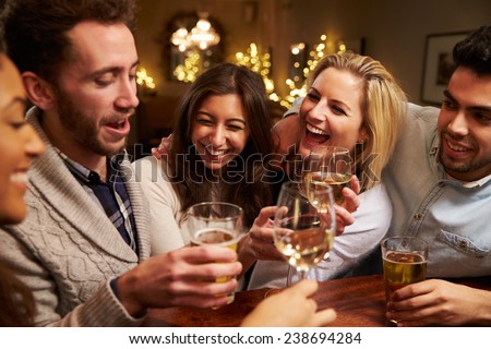 Group Of Friends Enjoying Evening Drinks In Bar