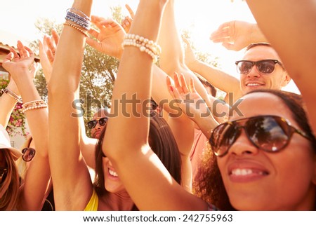 Group Of Young People Enjoying Outdoor Music Festival