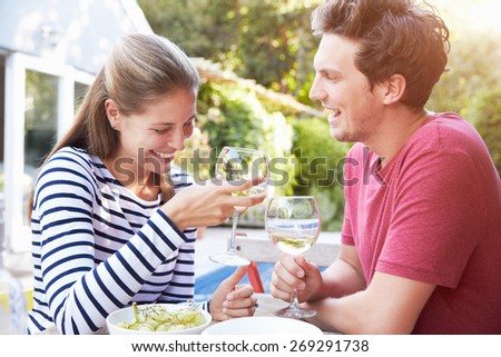 Couple Enjoying Outdoor Drinks In Garden