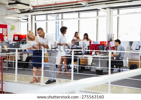 Staff working in a busy office mezzanine