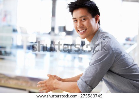 Similar – Image, Stock Photo Contemplative Asian man leaning on hand against brick building