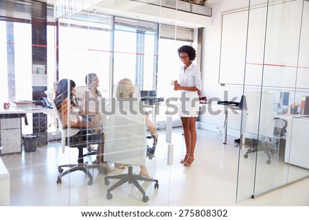 Businesswoman presenting meeting in an office